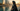 Woman in deep teal embellished abaya on the Bahrain Financial Harbour waterfront at golden hour