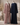 Open-front dusty pink abaya and closed navy blue abaya side by side on mannequins in an elegant studio setting