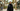 Woman in elegant structured black nidha abaya walking in modern Doha
